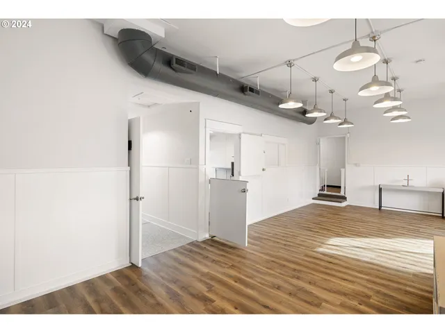 a view of an entryway with wooden floor