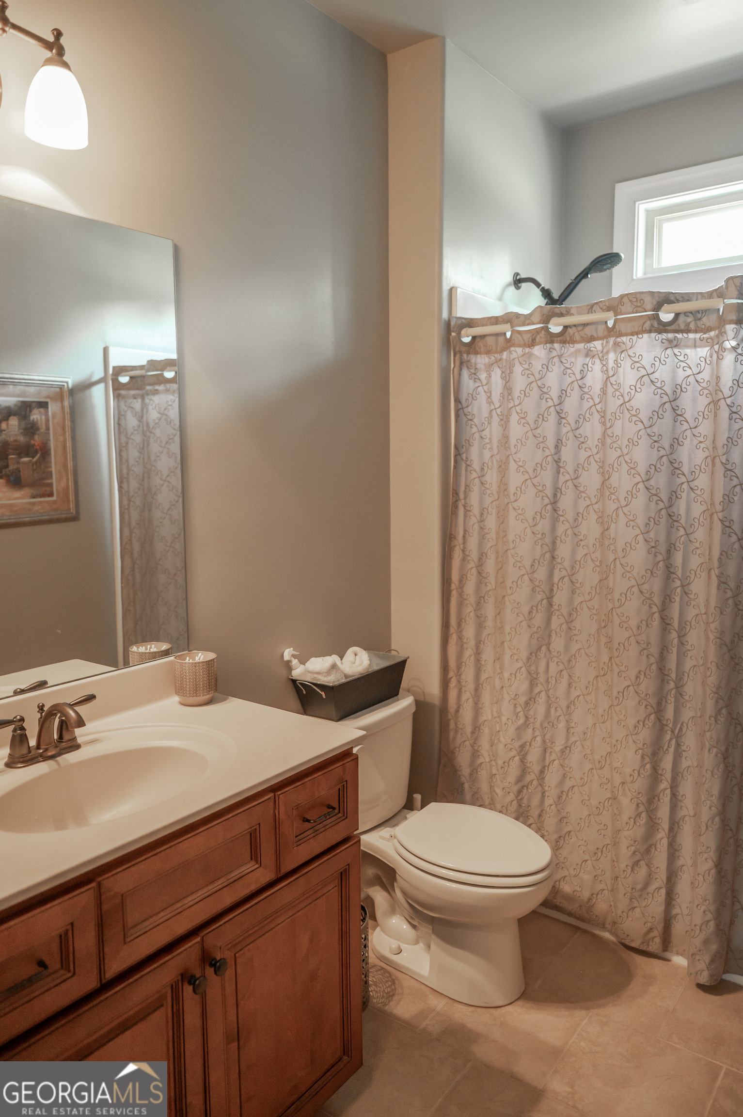 415 EAS Way Fayetteville, GA 30215 - Photo 21 of 70 a bathroom with a sink a toilet a mirror and shower curtain