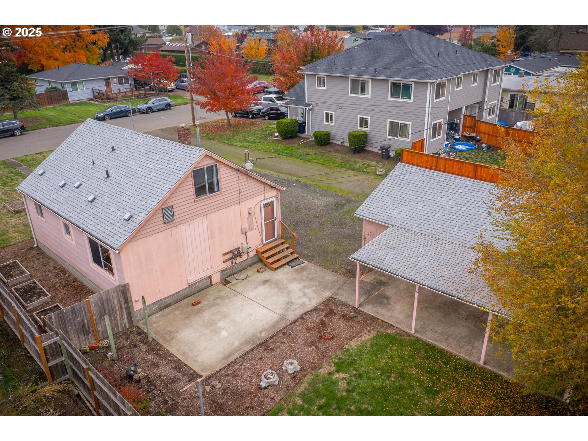 505 Broad Street South Monmouth, OR 97361 - Photo 27 of 28 an aerial view of a house with garden space and a car parked