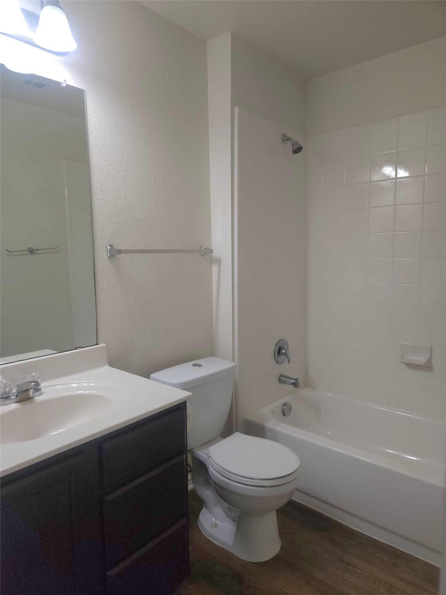 160 Rummel Drive Kyle, TX 78640 - Photo 10 of 13 A well-appointed bathroom with wood-look flooring and a functional bath and shower combination.