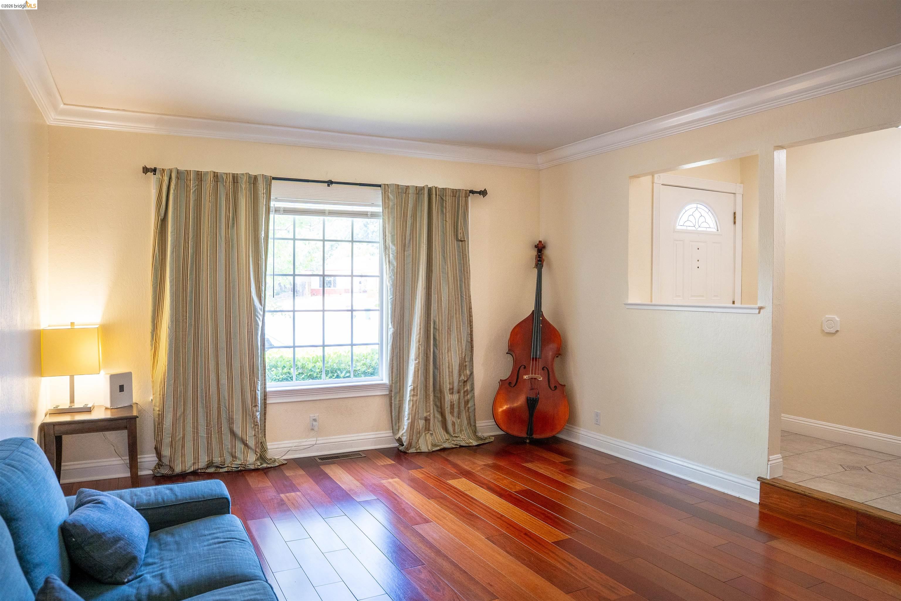 3513 Rio Grande Drive Antioch, CA 94509 - Photo 5 of 22 Living space featuring rich wood-finish flooring, crown molding, and a large multi-pane window