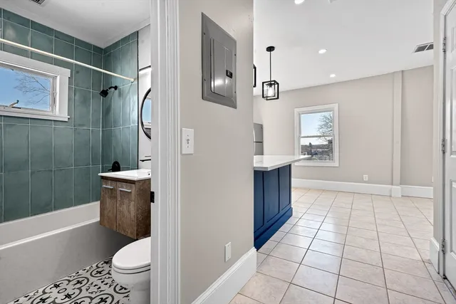 a bathroom with a sink a toilet and shower