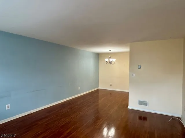 a view of an empty room and wooden floor