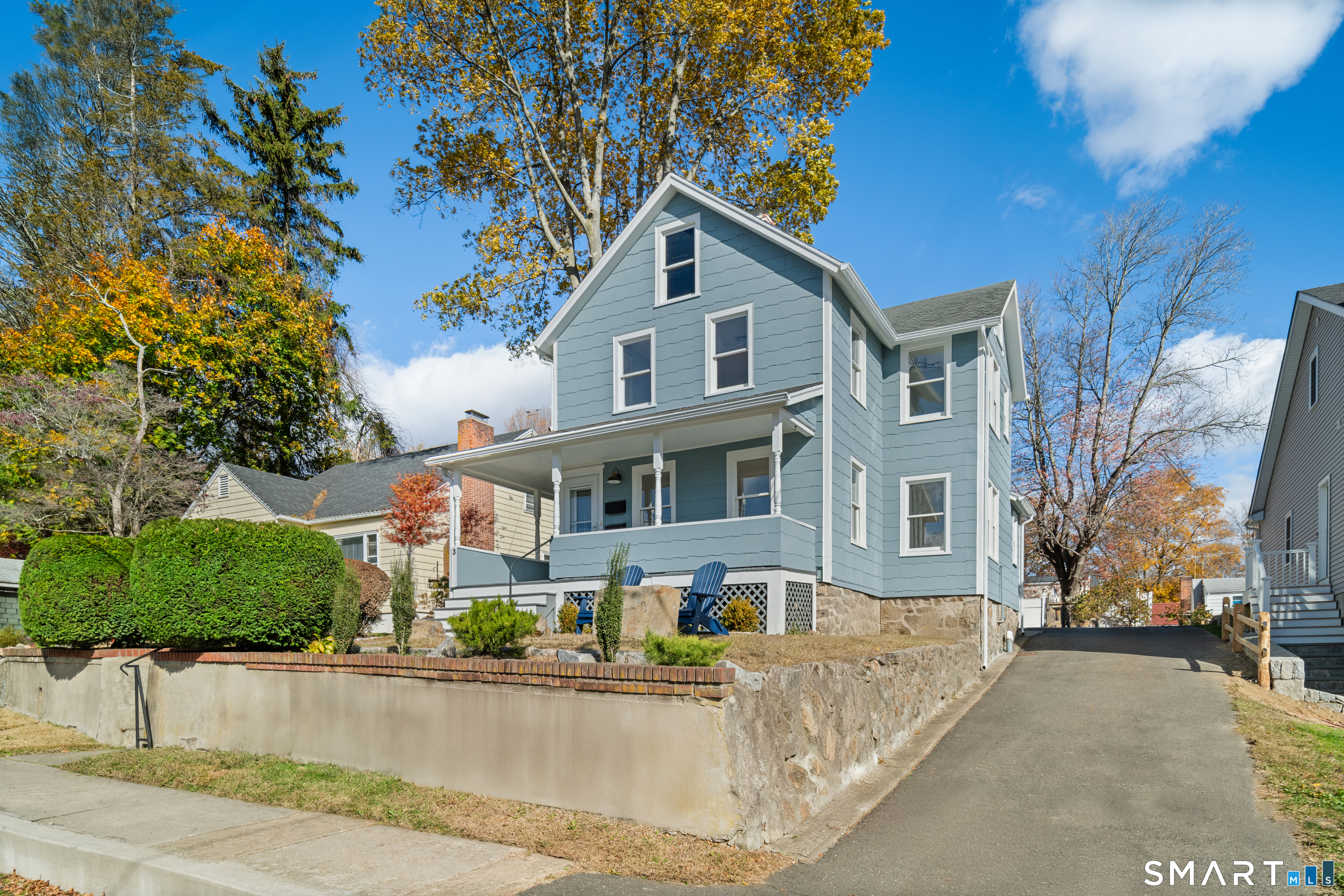 a front view of a house with yard and trees