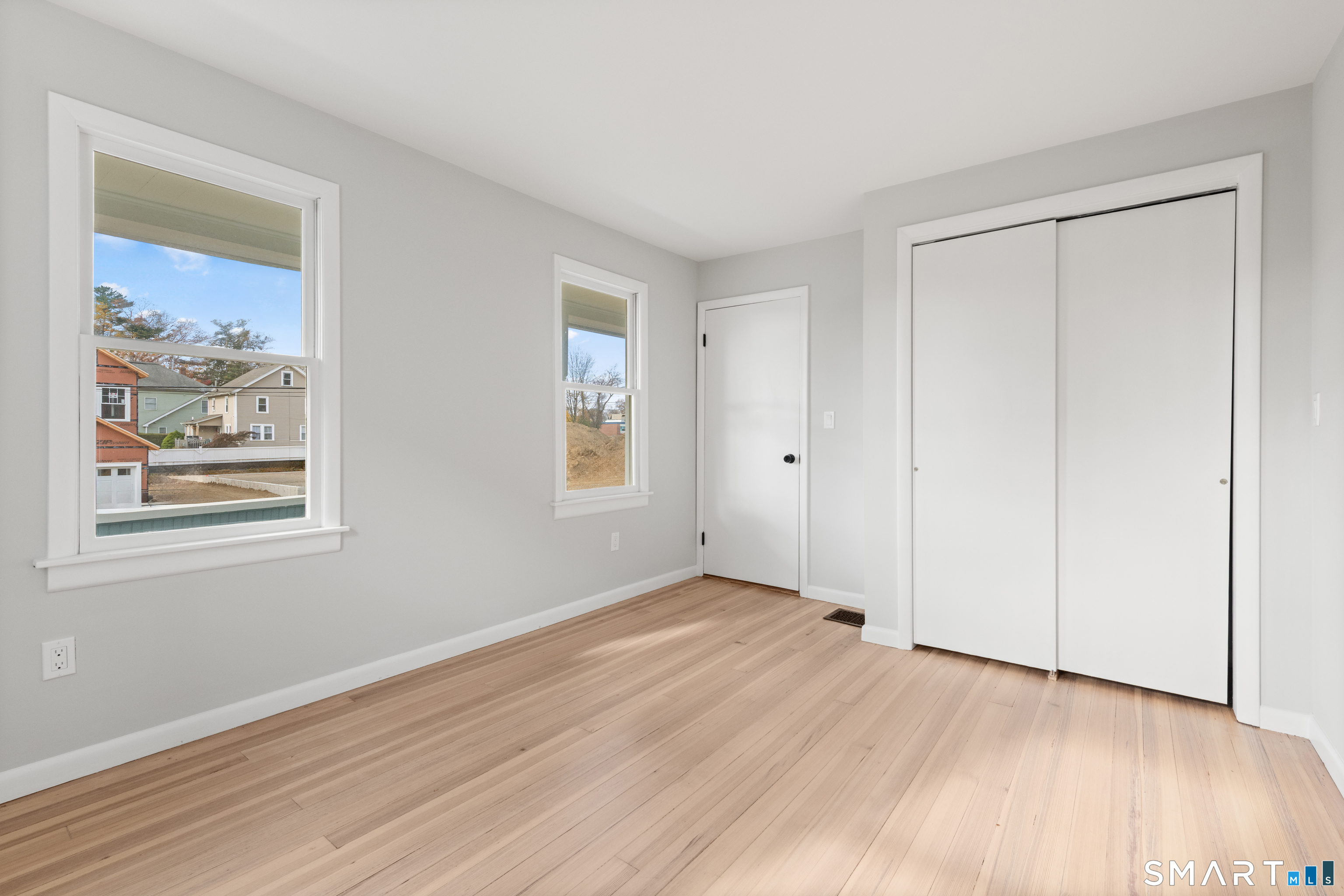 3 Edgewood Street Norwalk, CT 06854 - Photo 12 of 23 a view of an empty room with wooden floor and a window