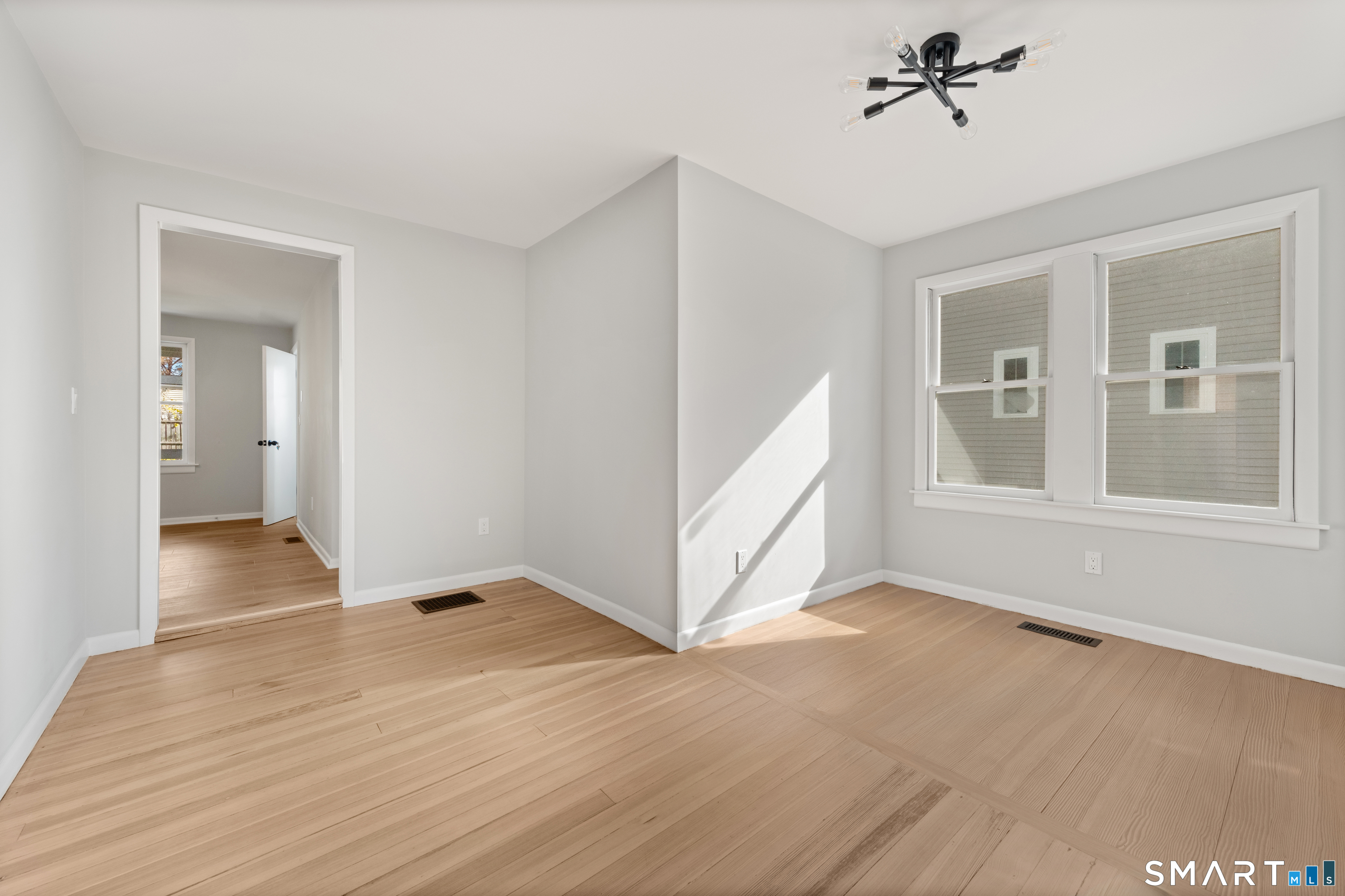 3 Edgewood Street Norwalk, CT 06854 - Photo 13 of 23 a view of an empty room with a window and wooden floor