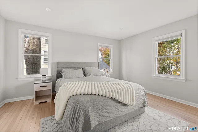 a large bed sitting in a bedroom next to a window