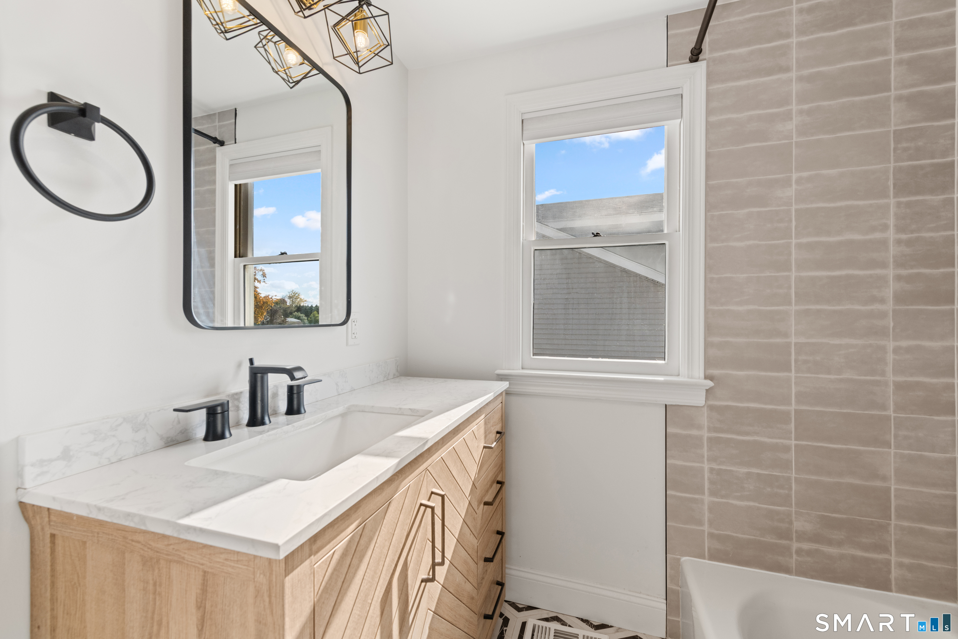 3 Edgewood Street Norwalk, CT 06854 - Photo 16 of 23 a bathroom with a sink double vanity and a mirror