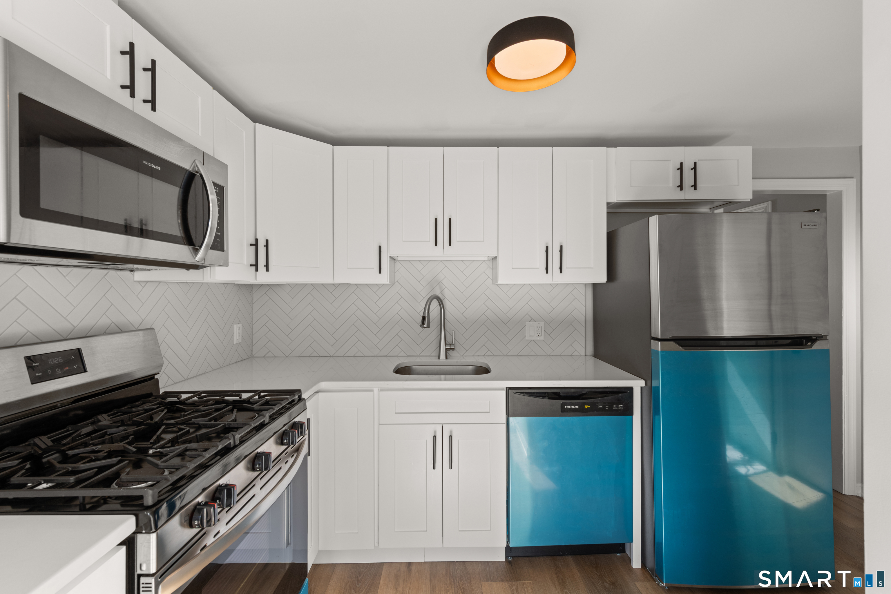 3 Edgewood Street Norwalk, CT 06854 - Photo 18 of 23 a kitchen with stainless steel appliances granite countertop a stove a refrigerator and a sink