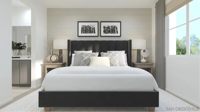 a bedroom with a large bed and a painting on the wall