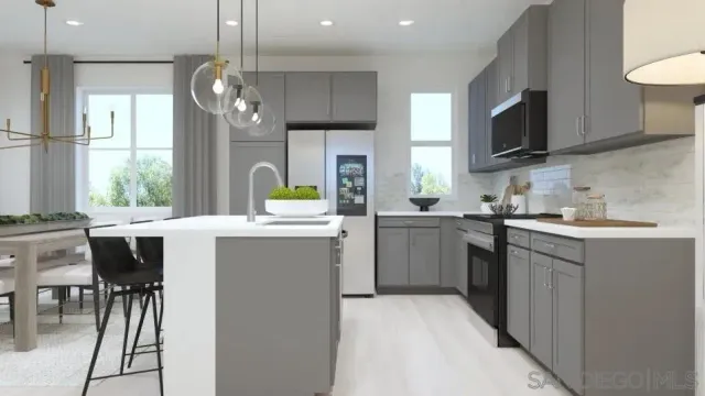 a kitchen with a sink stainless steel appliances and dining table