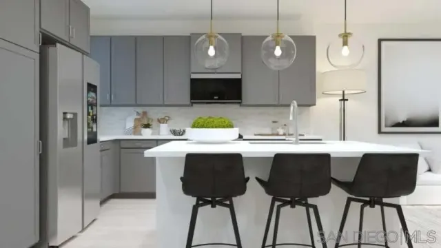 a kitchen with a table chairs sink and cabinets