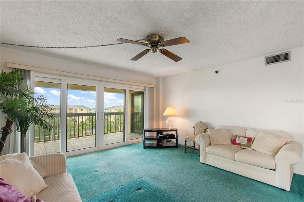 401 150th Avenue, Unit 251 Madeira Beach, FL 33708 - Photo 12 of 45 a living room with furniture and a chandelier