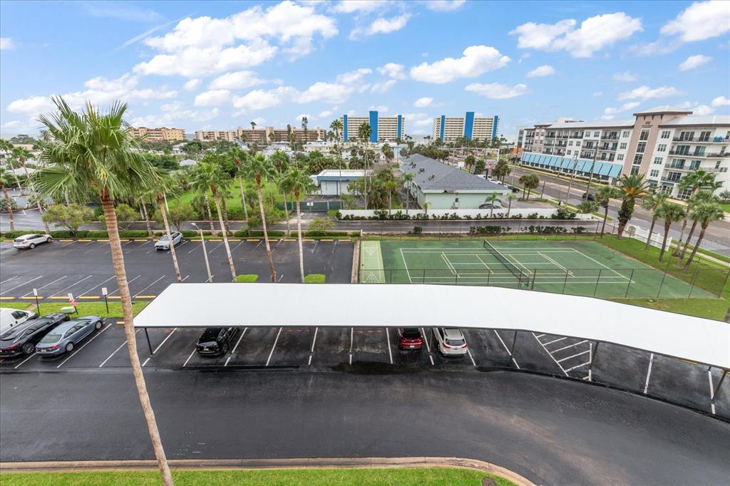 401 150th Avenue, Unit 251 Madeira Beach, FL 33708 - Photo 24 of 45 a view of a swimming pool with a bench and some trees