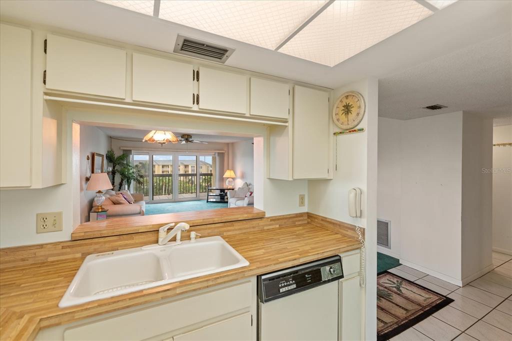 401 150th Avenue, Unit 251 Madeira Beach, FL 33708 - Photo 25 of 45 a kitchen with a stove and a refrigerator
