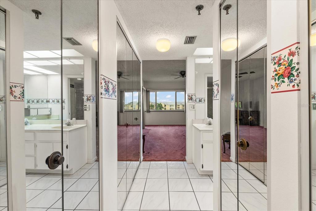401 150th Avenue, Unit 251 Madeira Beach, FL 33708 - Photo 26 of 45 a bathroom with a glass shower door and a glass door shower