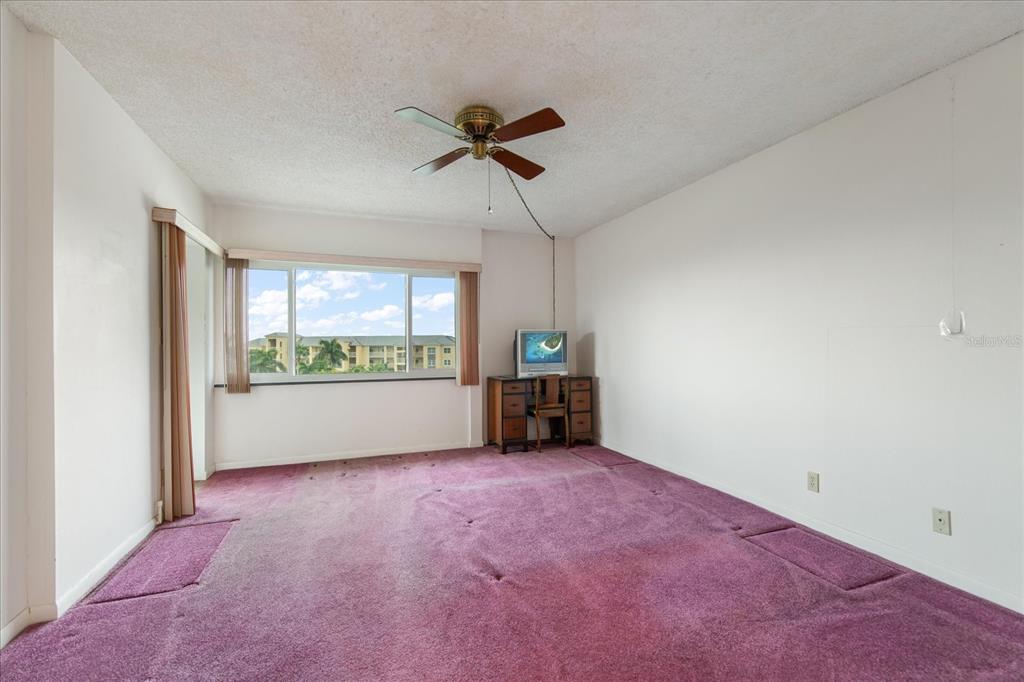 401 150th Avenue, Unit 251 Madeira Beach, FL 33708 - Photo 30 of 45 a view of room with window and a ceiling fan