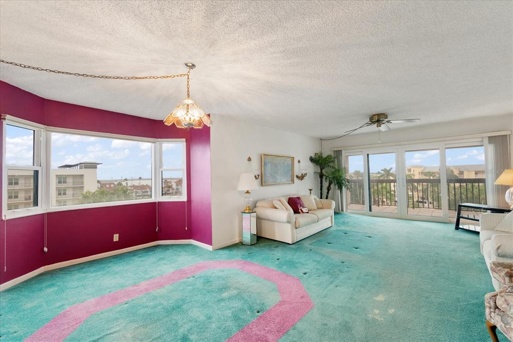 401 150th Avenue, Unit 251 Madeira Beach, FL 33708 - Photo 9 of 45 a spacious bedroom with a bed and large window