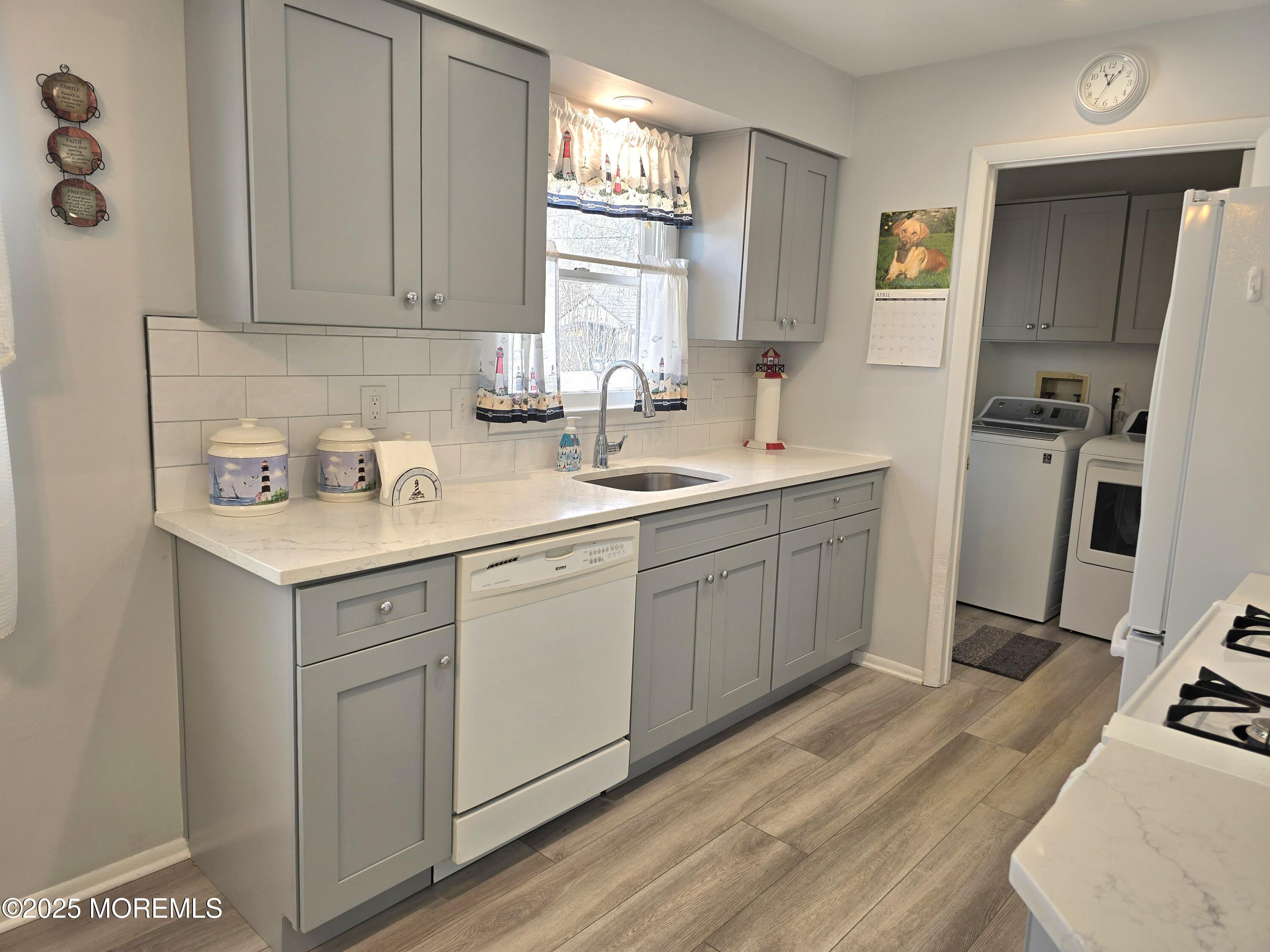 2126 Wainwright Road Toms River, NJ 08753 - Photo 12 of 28 a kitchen with a sink cabinets and appliances