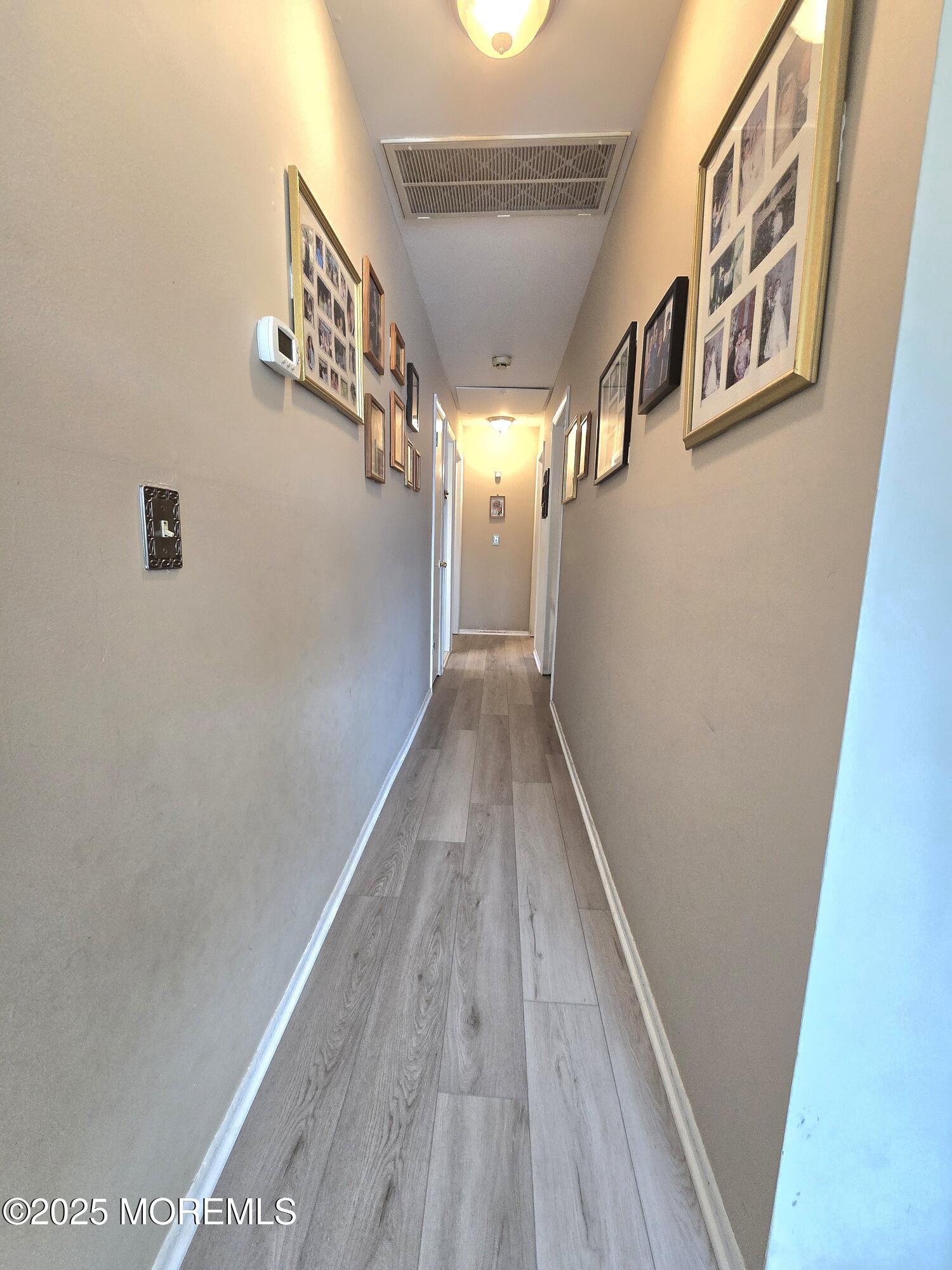 2126 Wainwright Road Toms River, NJ 08753 - Photo 14 of 28 a view of a hallway with wooden floor