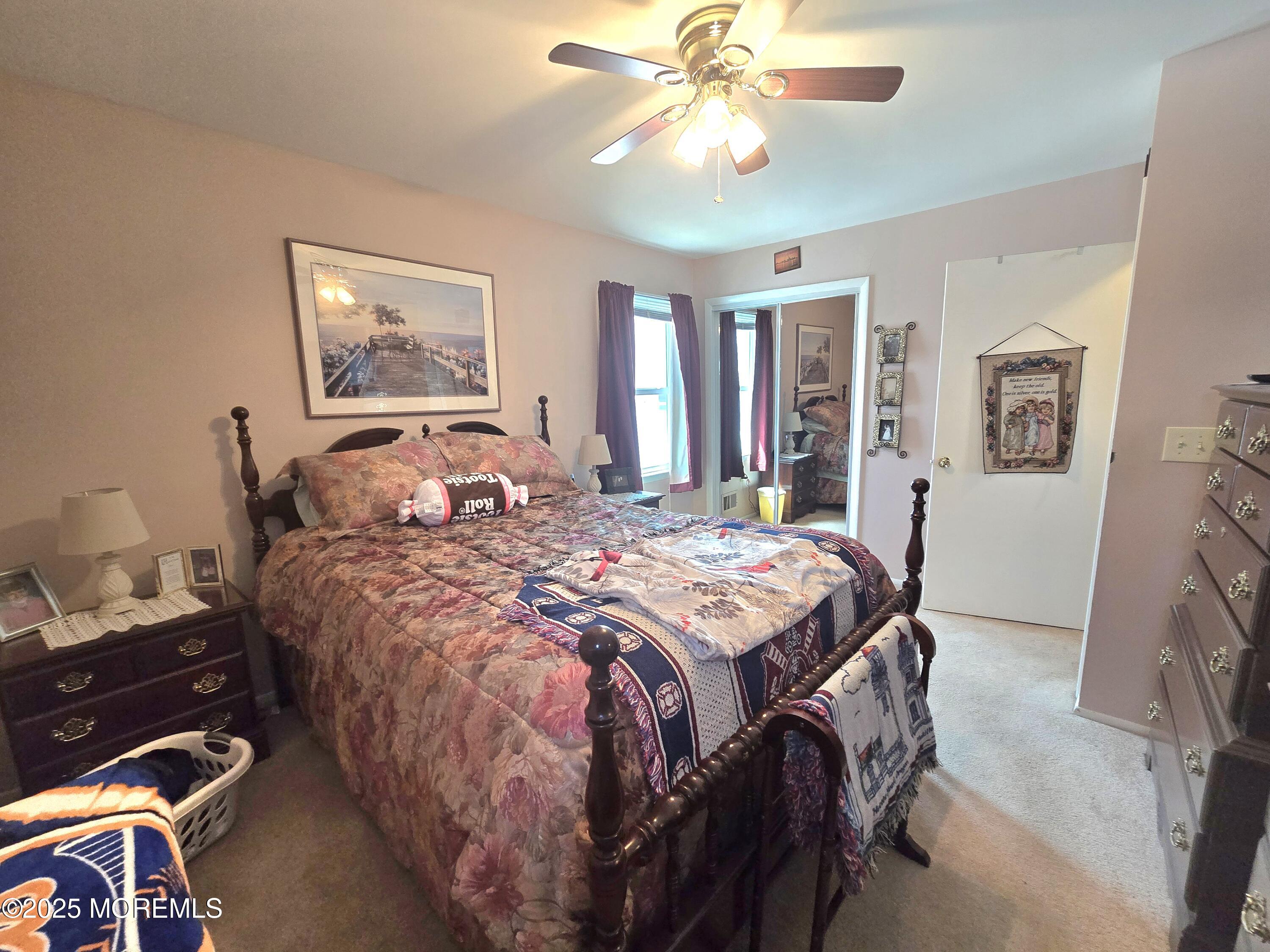2126 Wainwright Road Toms River, NJ 08753 - Photo 15 of 28 a bedroom with a bed and a chandelier