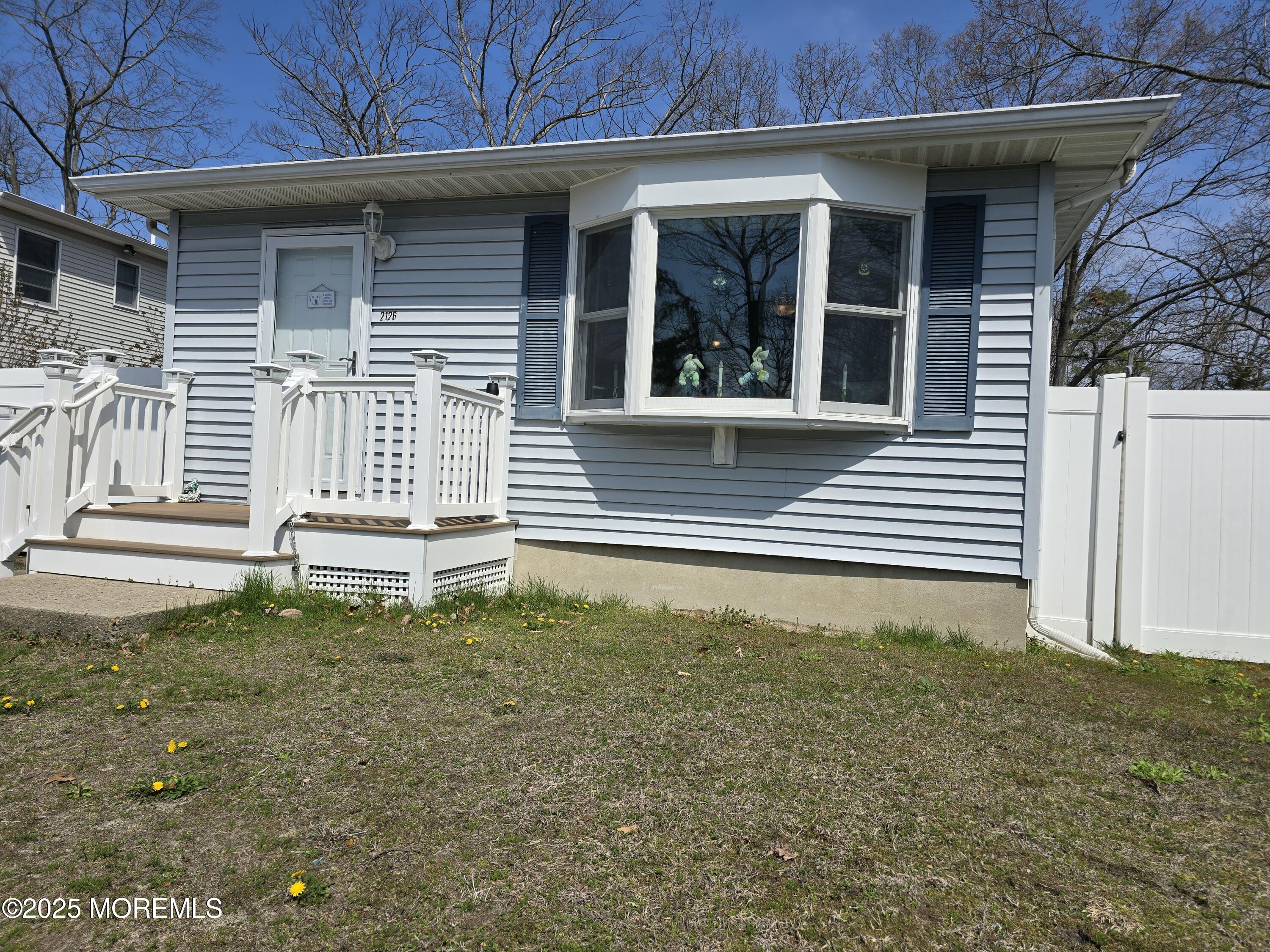 2126 Wainwright Road Toms River, NJ 08753 - Photo 2 of 28 a front view of a house with a yard