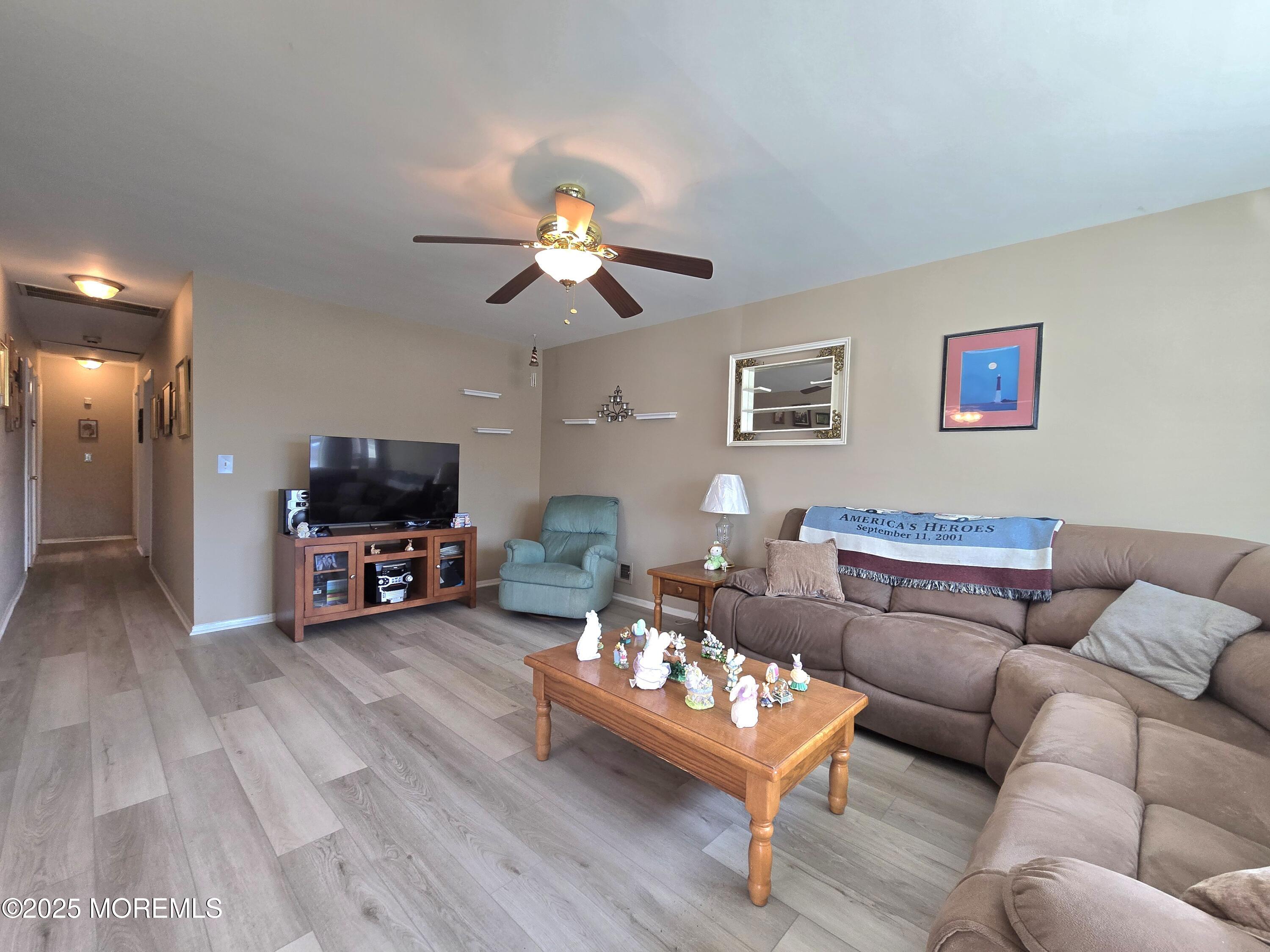 2126 Wainwright Road Toms River, NJ 08753 - Photo 6 of 28 a living room with furniture a flat screen tv and a couch