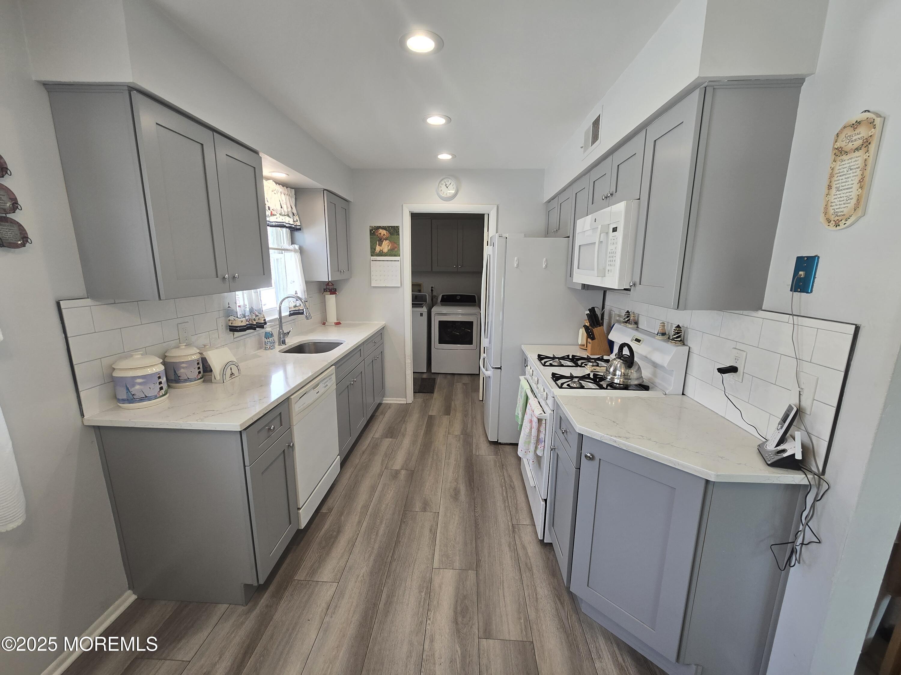 2126 Wainwright Road Toms River, NJ 08753 - Photo 8 of 28 a kitchen with a sink stove and refrigerator