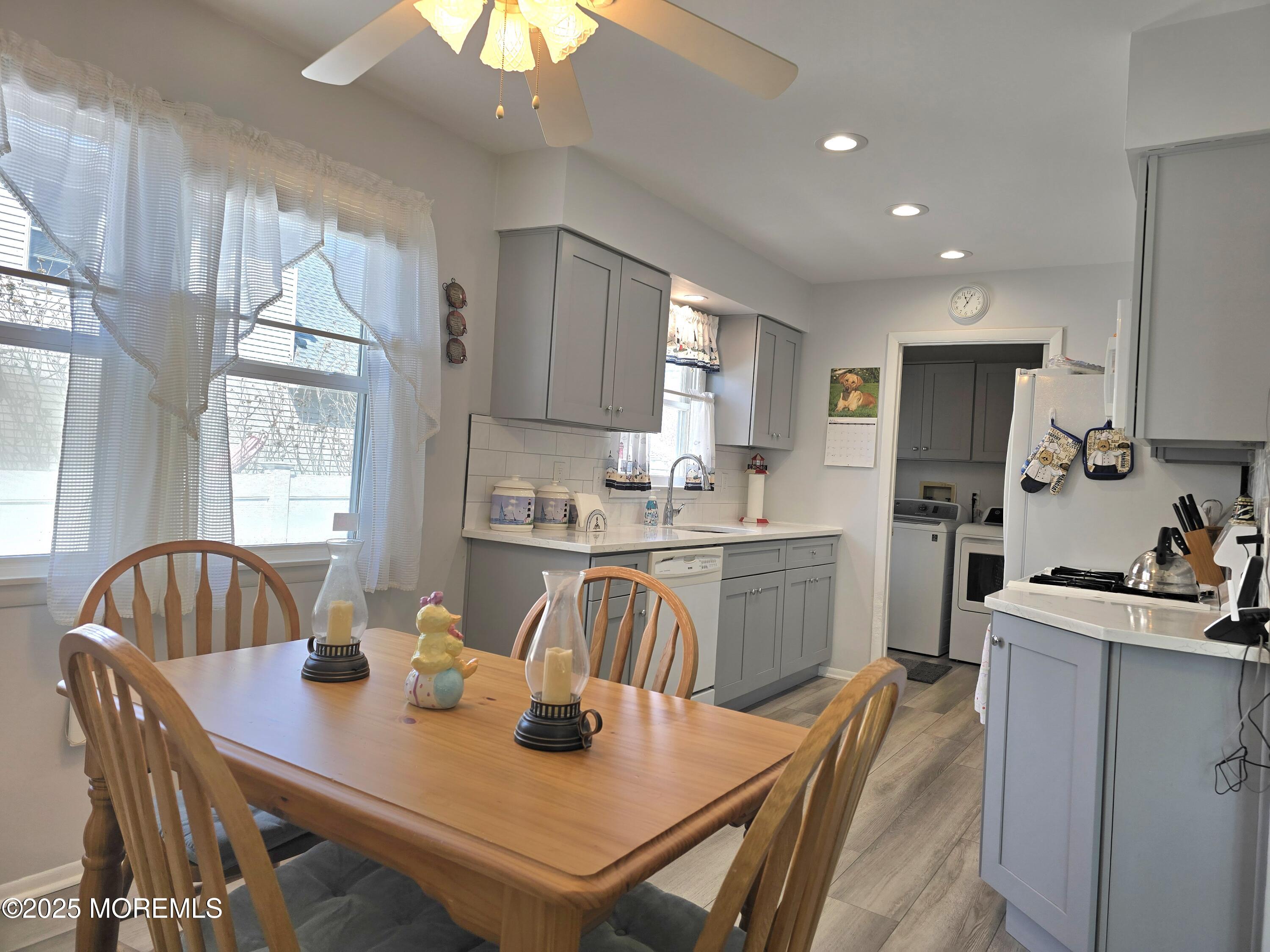 2126 Wainwright Road Toms River, NJ 08753 - Photo 10 of 28 a kitchen with a dining table chairs and refrigerator