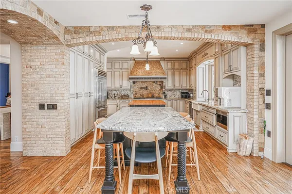 a view of a dining room with furniture wooden floor and chandelier