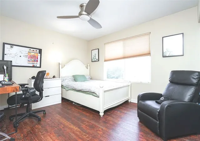 a living room with a bed furniture and a large window