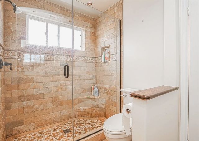 a bathroom with a tub and shower