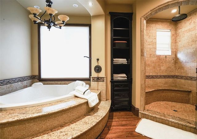 a view of a chairs and table in backyard of the house