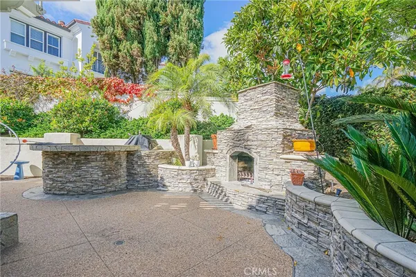 a view of a patio with a table and chairs and potted plants