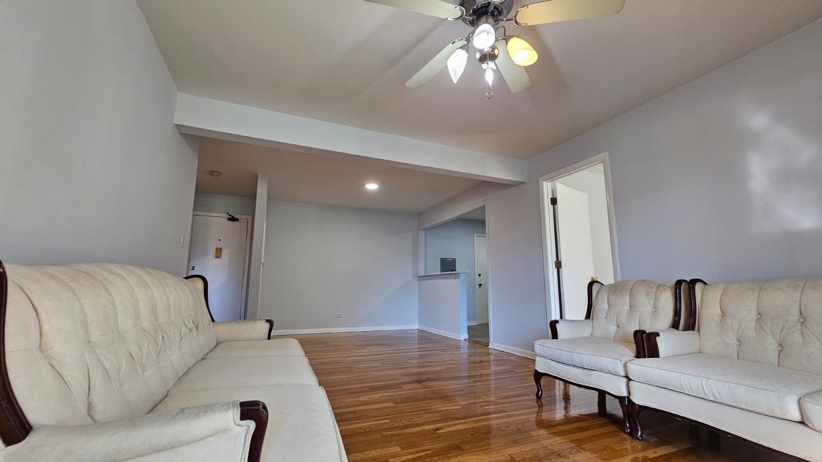9588 Terrace Place, Unit 1C Des Plaines, IL 60016 - Photo 4 of 8 a living room with furniture and a chandelier