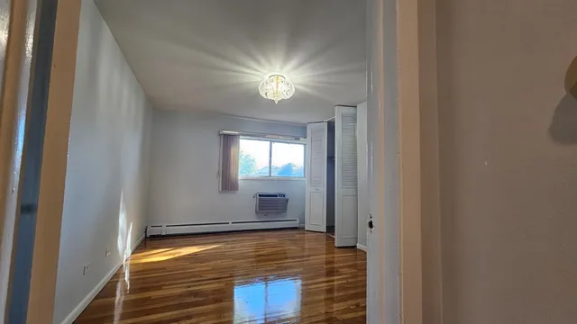 a view of room with a ceiling fan and window