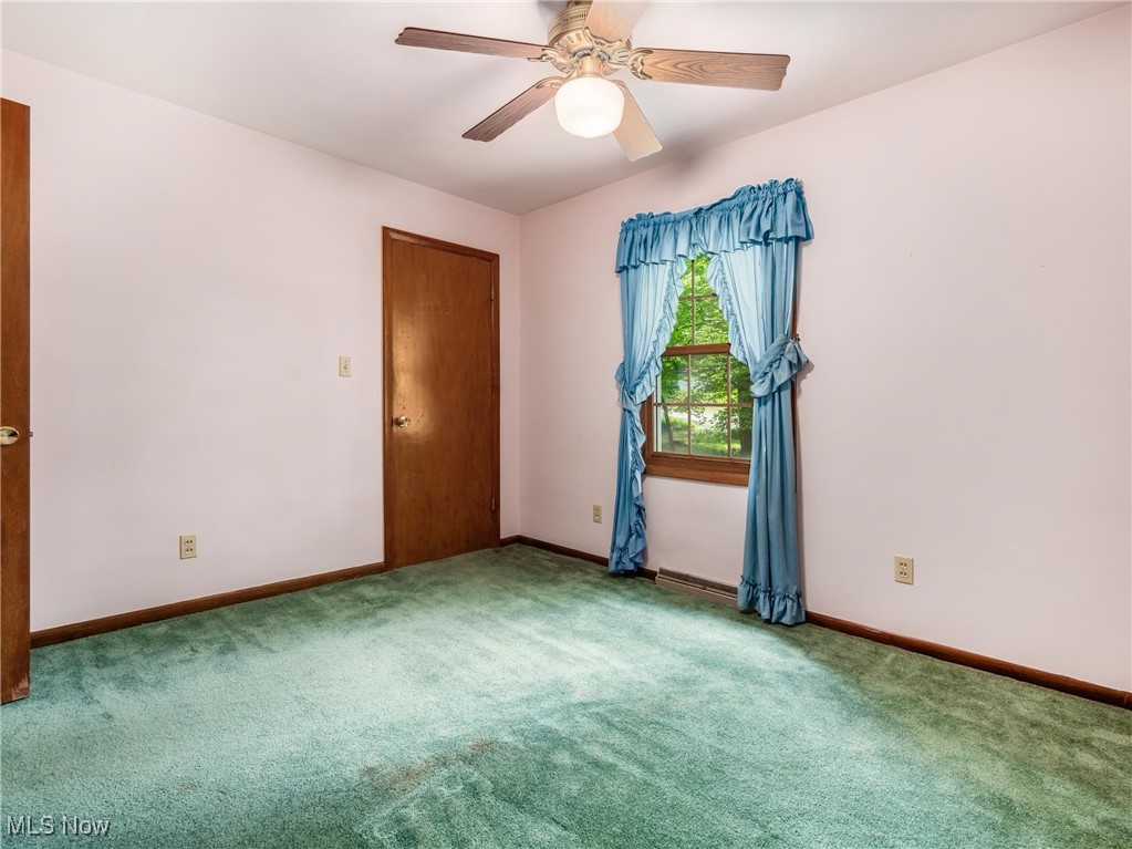 975 Richey Road Zanesville, OH 43701 - Photo 16 of 27 Carpeted spare room with baseboards and a ceiling fan