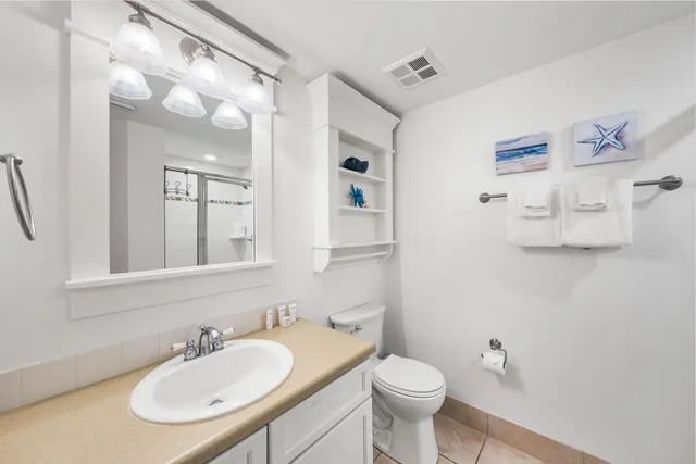 a bathroom with a sink toilet a mirror and vanity