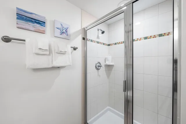 a bathroom with a shower and a glass door