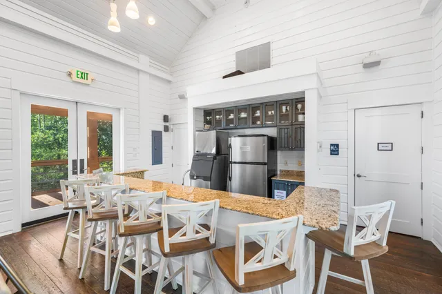 a living room with large windows and furniture
