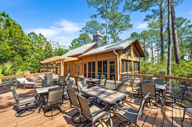 a view of a patio with couches table and chairs and potted plants