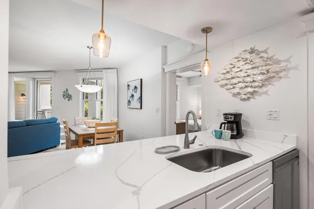 a kitchen with a sink and chandelier