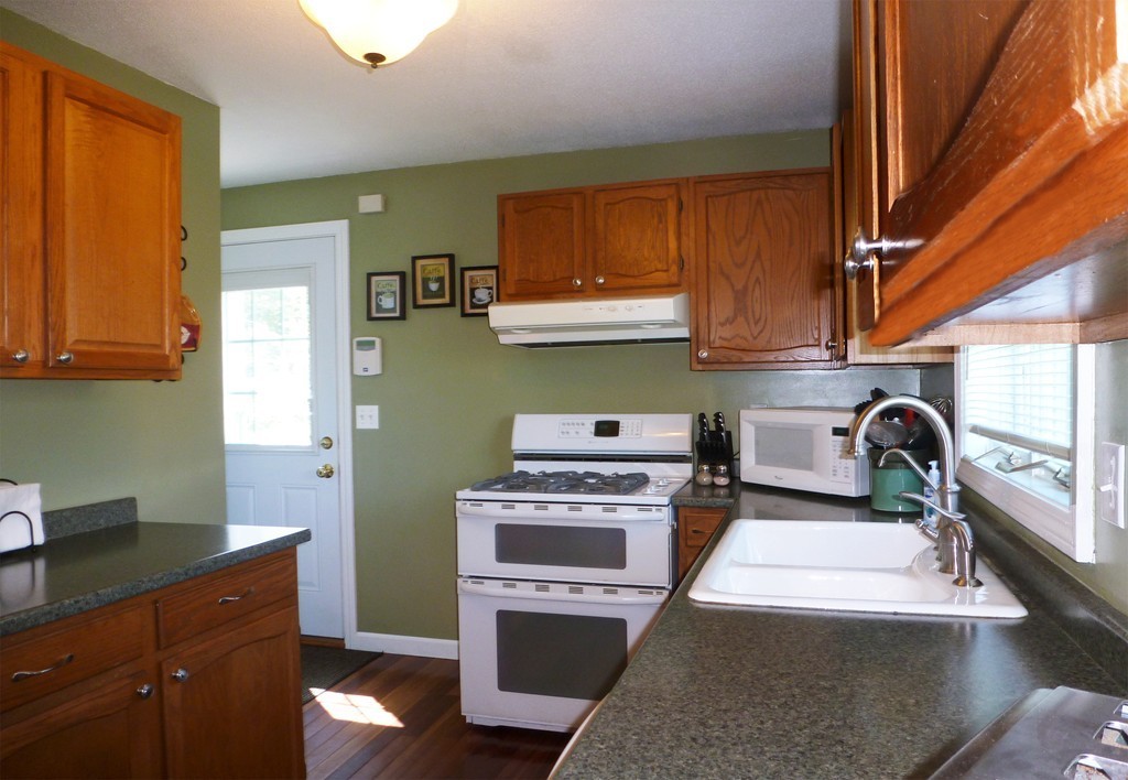 15 Old Wales Road Monson, MA 01057 - Photo 3 of 24 a kitchen with stainless steel appliances granite countertop a stove a sink and a microwave