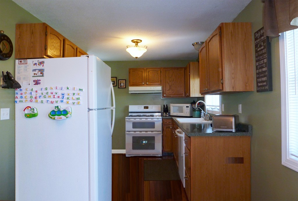 15 Old Wales Road Monson, MA 01057 - Photo 4 of 24 a kitchen with a refrigerator a stove top oven a sink and dishwasher