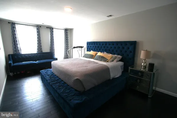 a bedroom with a bed and a mirror