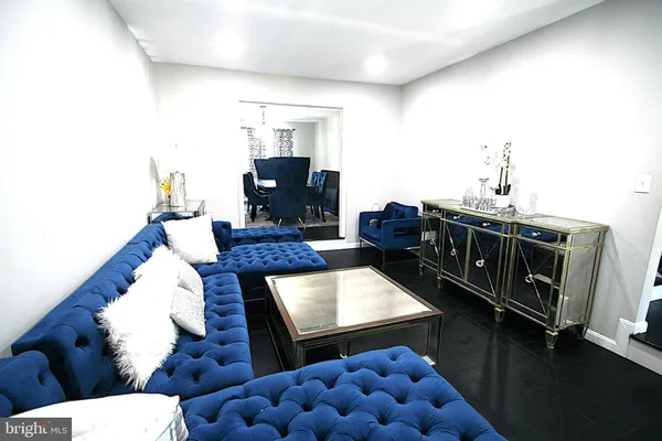 a kitchen with stainless steel appliances a refrigerator a sink a stove a dining table and chairs