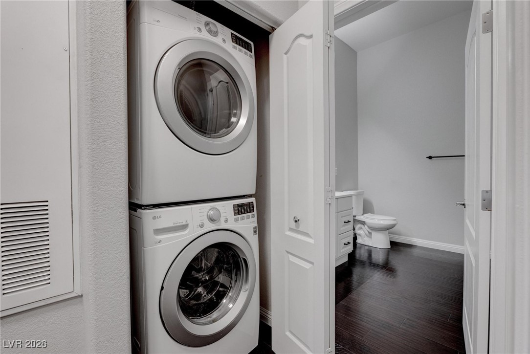 2305 West Horizon Ridge Parkway, Unit 3921 Henderson, NV 89052 - Photo 14 of 31 Laundry room with stacked washing machine and dryer and dark wood-type flooring