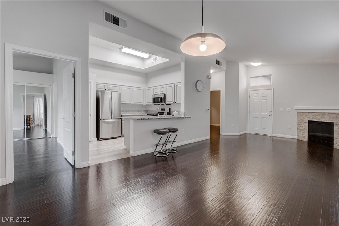 2305 West Horizon Ridge Parkway, Unit 3921 Henderson, NV 89052 - Photo 31 of 31 Kitchen with stainless steel appliances, a peninsula, open floor plan, and wood finished floors
