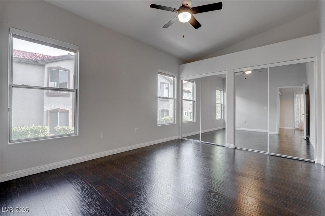 2305 West Horizon Ridge Parkway, Unit 3921 Henderson, NV 89052 - Photo 2 of 31 Unfurnished bedroom featuring multiple closets, lofted ceiling, wood finished floors, and ceiling fan