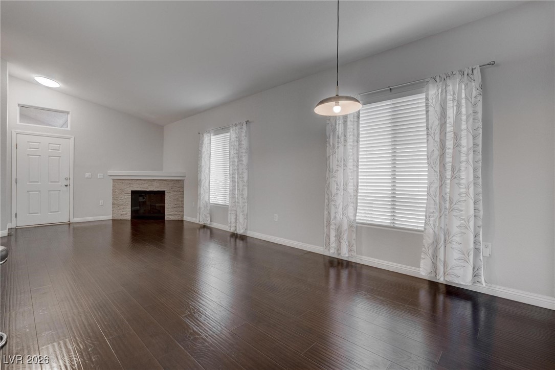 2305 West Horizon Ridge Parkway, Unit 3921 Henderson, NV 89052 - Photo 26 of 31 Unfurnished living room with lofted ceiling, wood finished floors, and a tile fireplace